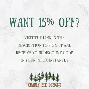 May include: Text-based graphic with the words "WANT 15% OFF?" in dark green. The text encourages viewers to visit a link to sign up and receive a discount code. The graphic includes a row of pine trees and the brand name "CHARLY BEE DESIGNS."