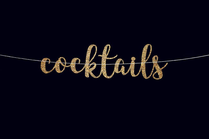 May include: Gold glitter banner with the word "cocktails" hanging on a white string against a black background.