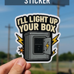 May include: A sticker with the text "FUNNY ELECTRICIAN STICKER" at the top. The sticker features an illustration of an electrical box with the text "I'LL LIGHT UP YOUR BOX". Lightning bolt graphics are on the sticker.