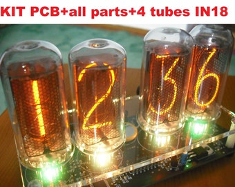 May include: A kit with a PCB and all parts, including four IN18 tubes. The tubes display illuminated numbers 1, 2, 3, and 6 in a warm orange hue. The text "KIT PCB+all parts+4 tubes IN18" is visible at the top. The tubes are mounted on a clear acrylic base.
