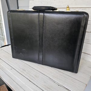 May include: A set of three ceramic nesting bowls in shades of blue, green, and white. The bowls feature a speckled glaze and a simple, modern design. The largest bowl is approximately 7 inches in diameter.