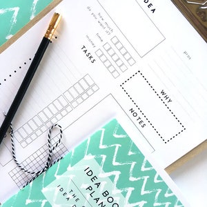 May include: A white printable planner with a teal and white patterned cover. The planner is titled "Idea Booster Planner" and includes sections for "Idea", "Tasks", "Why", "Notes", and "Pros".