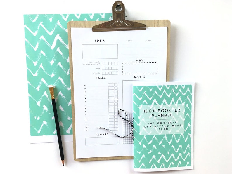 May include: A teal and white chevron patterned planner with the title "Idea Booster Planner: The Complete Idea Development Plan".