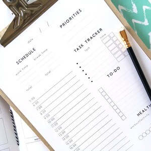 May include: A white printable planner with sections for scheduling, task tracking, to-do lists, and health goals. The planner has a simple design with black text and bullet points.