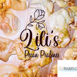 May include: A collection of light brown pecan pralines with a glossy sugar coating. The text Lili's Pecan Pralines is centered with a floral line drawing above it. A small white rectangular logo in the corner reads DealMAKES CENTS.