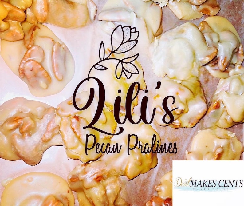 May include: A collection of light brown pecan pralines with a glossy sugar coating. The text Lili's Pecan Pralines is centered with a floral line drawing above it. A small white rectangular logo in the corner reads DealMAKES CENTS.