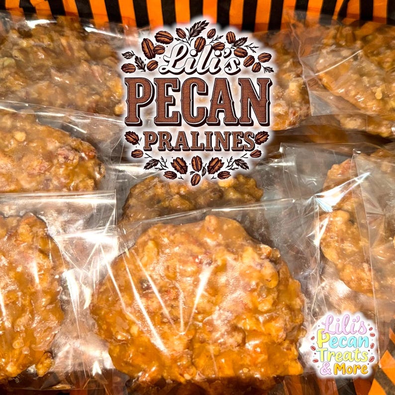 May include: Multiple individual pecan pralines, each encased in a clear plastic wrapper. The candies feature a golden-brown, textured surface with visible nut pieces. A central logo reads Lili's PECAN PRALINES, and a smaller label says Lili's Pecan Treats & More.