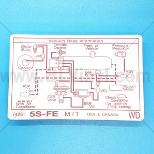 May include: Rectangular white sticker with a diagram of a car's vacuum hose system. The diagram includes labels such as "Vacuum Hose Information," "Throttle Opener," and "EGR Valve." The text "5S-FE M/T USA & CANADA" is also present.