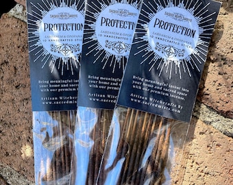 May include: Three packs of incense sticks labelled "Protection" with the text "Labdanum & Opopanax 10 Handcrafted Sticks" and the brand name "Sacred Mists Shoppe".