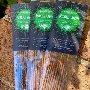 May include: Three packages of incense sticks labeled "Middle Earth" with the text "Sweetgum & Maple Leaves 10 Handcrafted Sticks". The incense sticks are brown and packaged in clear plastic.