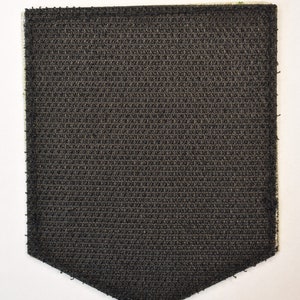 May include: A black hook and loop fastener patch with a textured surface.