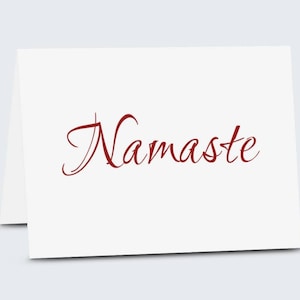 May include: A white card with the word "Namaste" written in red cursive script.