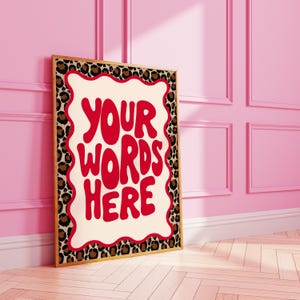 Puede incluir: Una impresión enmarcada con un borde de estampado de leopardo y un fondo blanco. El texto "YOUR WORDS HERE" está escrito en letras rojas.