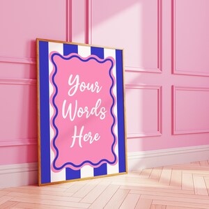 May include: A framed poster with a blue and white striped background. The poster has a pink frame with the words "Your Words Here" in white.