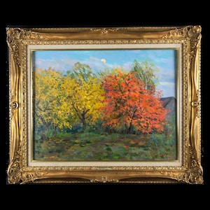 May include: An oil painting depicting a landscape with three trees in the foreground. The trees are in various shades of green, yellow, and red. The painting is framed in a gold frame.