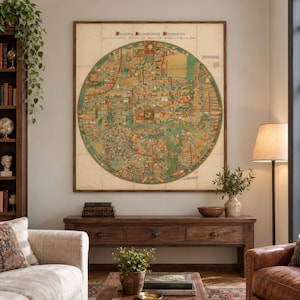 May include: A large, square, framed wall art piece featuring a circular medieval-style map with intricate illustrations, text, and muted green, tan, and red tones. The map is centered on a light-colored wall above a dark wooden console table.