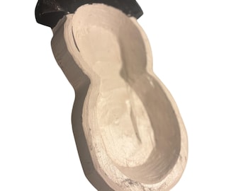 May include: A handmade wooden scoop with a light beige finish and a black handle. The scoop has a rounded bowl shape and is likely used for serving or measuring dry ingredients. The design is simple and rustic.