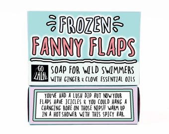 May include: A box of soap with the text "FROZEN FANNY FLAPS" in pink and black. The box is light blue with the text "SOAP FOR WILD SWIMMERS WITH GINGER & CLOVE ESSENTIAL OILS". The bottom of the box has text in a white box.