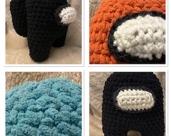 May include: Four crocheted plush toys shaped like the characters from the video game Among Us. The toys are black, orange, blue, and black with a white visor.