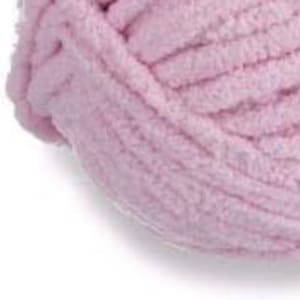 May include: A close-up of a ball of soft, light pink yarn. The yarn is made of a fuzzy, chenille-like material.