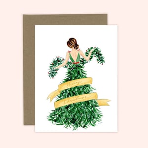 Op de afbeelding: Een aquarel-illustratie van een vrouw die een groene kerstboomjurk draagt met een rood lint en een gouden lint met de tekst "Merry Christmas".