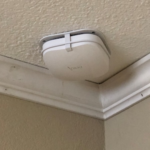 May include: A white ceiling-mounted wireless router with the word "eero" printed on it.