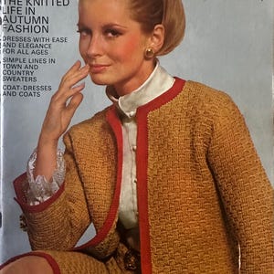 May include: Vintage Vogue Knitting magazine cover featuring a woman in a mustard yellow suit with red trim. The cover text reads "The Knitted Life in Autumn Fashion." The woman is wearing a white blouse with lace cuffs and gold earrings.
