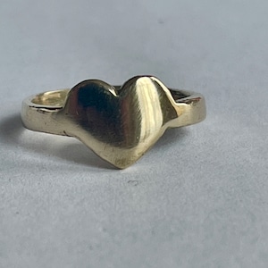 Flat Heart Ring - Crushed by external forces, thin and wan from exertion.