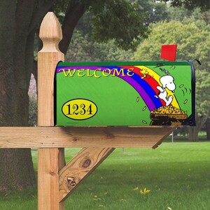 May include: A green mailbox with a welcome sign and a cartoon dog running towards a pot of gold at the end of a rainbow. The mailbox has a yellow oval with the number 1234 on it.