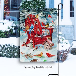 May include: A garden flag featuring a red Adirondack chair covered in snow, with various colorful birds perched on it. A birdhouse is also visible. The flag is set against a snowy winter scene.