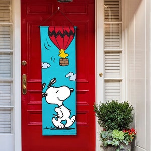 PEANUTS® Up and Away Snoopy and Woodstock - Front Door Banner – 15″ X 47″, Outdoor/Indoor, Vibrant Colors, Ready to Hang, Licensed PEANUTS®