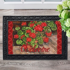 May include: Welcome doormat with a red and green floral design featuring geraniums in pots. The doormat has a black border with a decorative pattern.