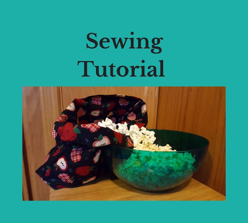 Sewing tutorial to make a reusable popcorn bag. This popcorn bag made of apple theme fabric has just come out the microwave and popped kernels are pouring out of it into a green bowl.