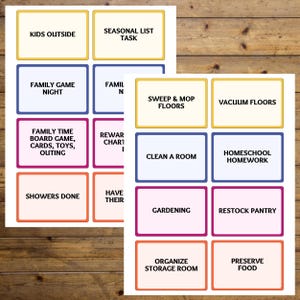 May include: Two sheets of paper with colorful rectangular labels, each with text. Labels include "Kids Outside," "Family Game Night," "Family Time Board Game," "Showers Done," "Seasonal List Task," "Sweep & Mop Floors," "Vacuum Floors," "Clean a Room," "Homeschool Homework," "Gardening," "Restock Pantry," "Organize Storage Room," and "Preserve Food."