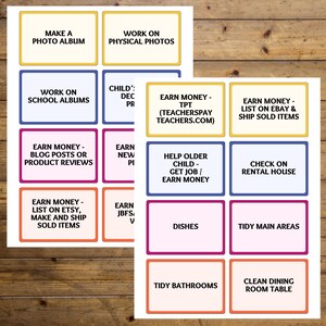 May include: Two sheets of paper with colorful rectangular labels. The labels have text such as "Make a Photo Album", "Earn Money - List on Etsy, Make and Ship Sold Items", and "Tidy Bathrooms". The labels are outlined in various colors.