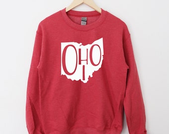 May include: Red sweatshirt with a white outline of the state of Ohio and the word "Ohio" written inside the outline.