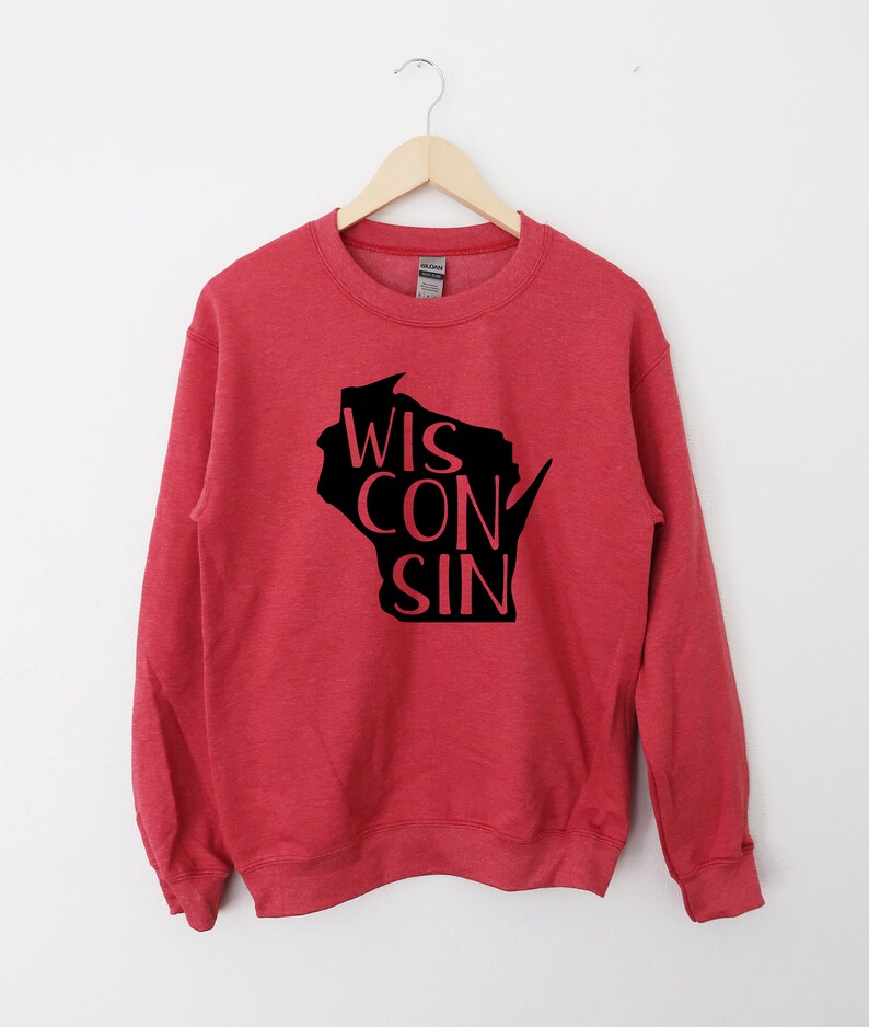 May include: Red sweatshirt with a black outline of the state of Wisconsin and the word "WISCONSIN" written inside the outline.
