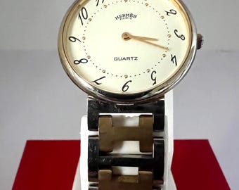 Reloj vintage Hermes unisex con esfera blanca.