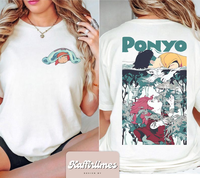 May include: Cream-coloured t-shirt with a cartoon illustration from the film "Ponyo". The front displays a small graphic of a character under a blanket. The back features a larger graphic with the word "Ponyo" in teal.