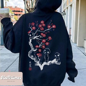 May include: Black hoodie featuring a white and red floral design with three small figures. The design includes Japanese text and a red seal. The hoodie has a drawstring hood and long sleeves. The brand name "Kaffirlimes" is printed at the bottom.