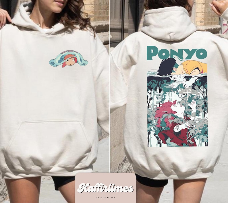 May include: Cream-coloured hoodie with a front pocket and hood. The front has a small cartoon graphic. The back of the hoodie features a larger graphic with the word "PONYO" and a detailed illustration of characters from the animated film.