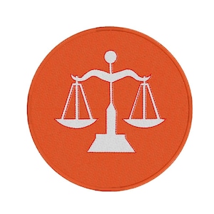 May include: Orange fabric circle patch with a white embroidered scale design.