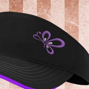 May include: Black visor with a purple butterfly embroidered on the front. The visor has a purple trim around the brim.