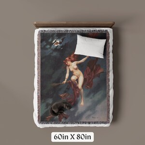 May include: A woven tapestry throw blanket featuring a vintage illustration of a woman flying on a broomstick under a crescent moon. The woman is nude and has long red hair. The background is a dark blue sky with clouds. The blanket is 60 inches by 80 inches.