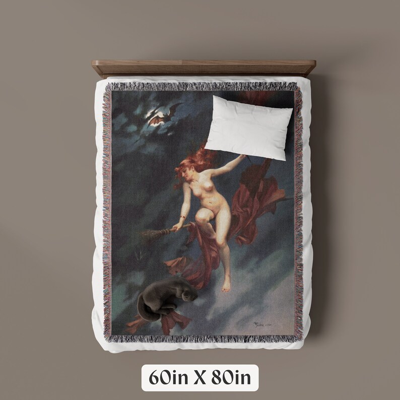 May include: A woven tapestry throw blanket featuring a vintage illustration of a woman flying on a broomstick under a crescent moon. The woman is nude and has long red hair. The background is a dark blue sky with clouds. The blanket is 60 inches by 80 inches.
