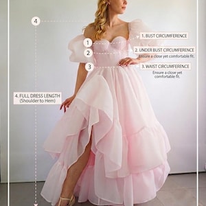 May include: A light pink, floor-length dress with puff sleeves, a sweetheart neckline, and a layered, ruffled skirt with a high side slit. The image includes a measurement guide labeled 1. BUST CIRCUMFERENCE, 2. UNDER BUST CIRCUMFERENCE, 3. WAIST CIRCUMFERENCE, and 4. FULL DRESS LENGTH (Shoulder to Hem), with the text EASY MEASUREMENT GUIDE FOR A PERFECT CUSTOM FIT.