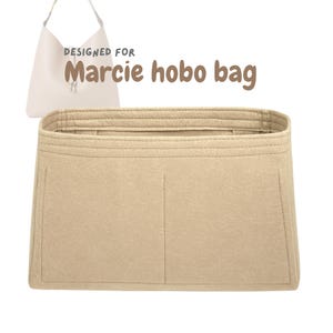 May include: Beige felt bag organiser designed for a Marcie hobo bag. The organiser has multiple compartments and a structured design. The text "DESIGNED FOR Marcie hobo bag" is visible in the image.