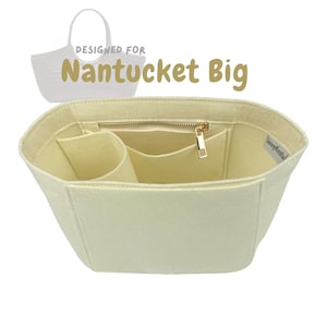 May include: Cream-colored felt bag organizer with multiple compartments and a zippered pocket. The text "DESIGNED FOR Nantucket Big" is visible in the upper portion of the image. The organizer is designed to fit inside a tote bag.