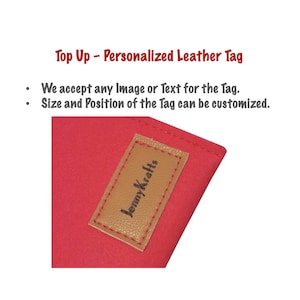 May include: A red leather tag with a brown leather patch that says "Jenny Krafts" in black lettering. The tag is personalized and can be customized with any image or text.