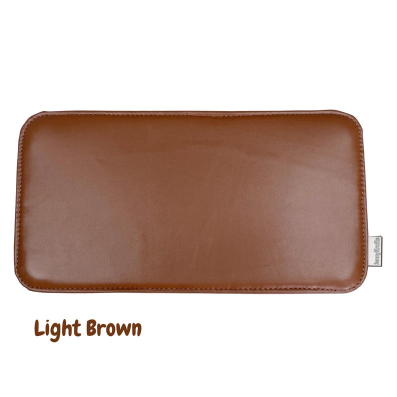 May include: A light brown rectangular leather item with rounded corners. The item has a smooth surface and a stitched border. The text "Light Brown" is at the bottom of the image.